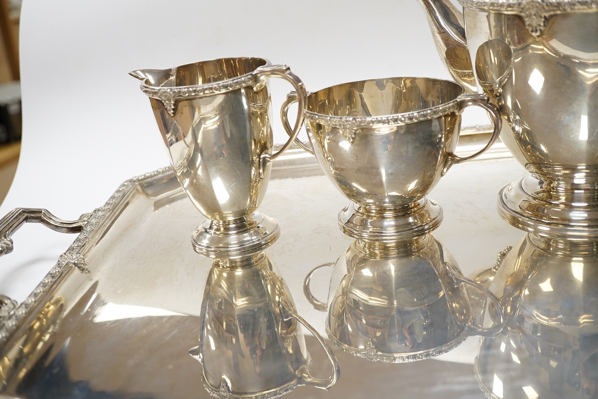 A George V silver five piece silver tea service including a two handled tea tray by Roberts & Belk, Sheffield, 1931/1934, tray 61.2cm over handles, gross weight 165.1oz. Condition - Fair to good